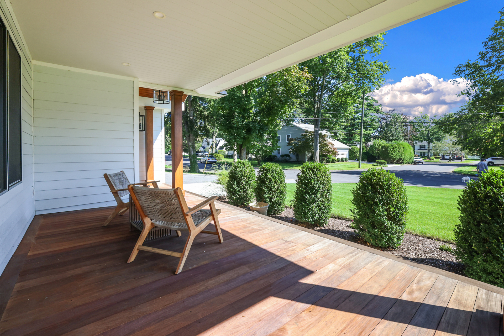Covered front porch with wood decking and street view