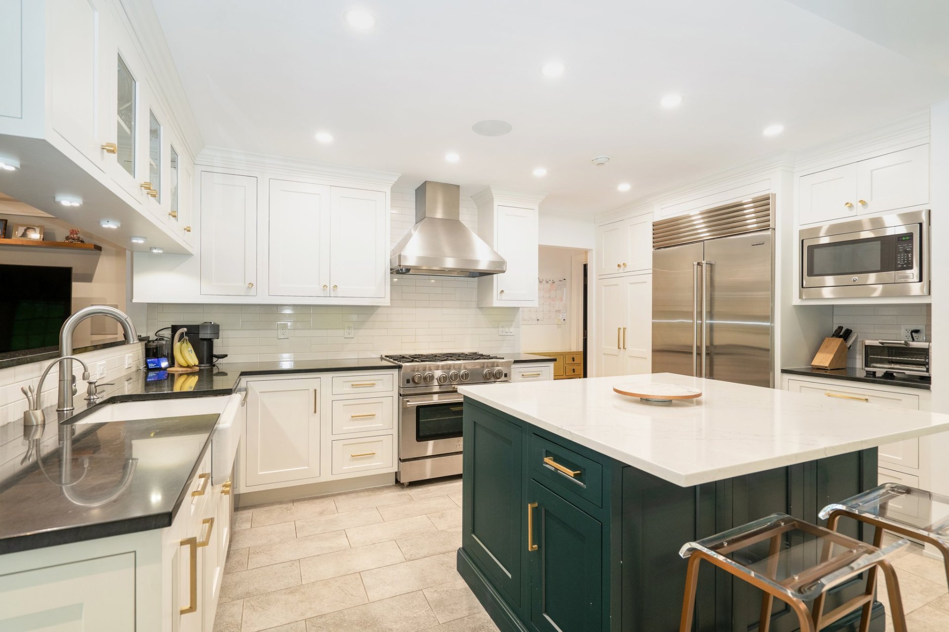 Chef's kitchen with emerald island and stainless appliances